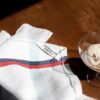 theedoek PUEBCO off white met rood en zwarte streep van recycled katoen